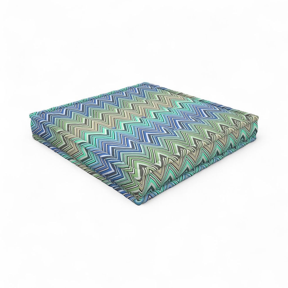 Zigzag patterned cushion with blue, green, and tan colors on white background