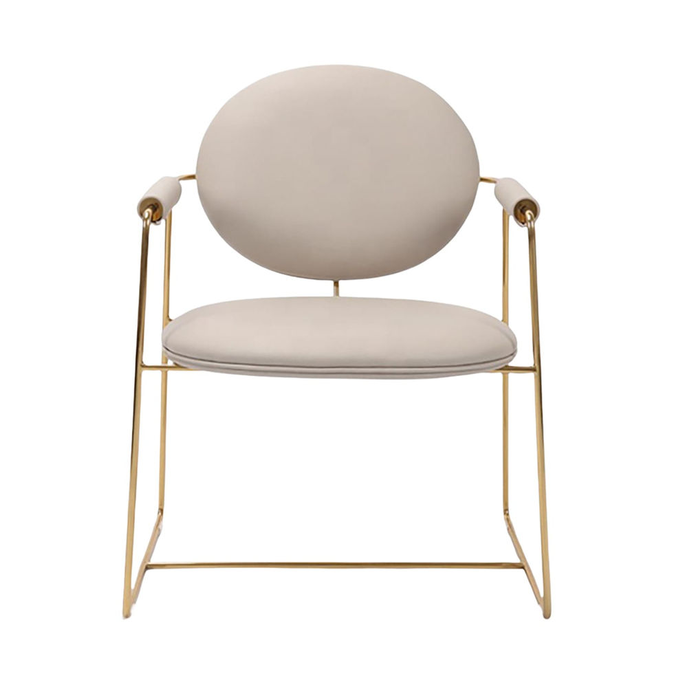 Cream upholstered chair with gold frame, modern design on a white background.