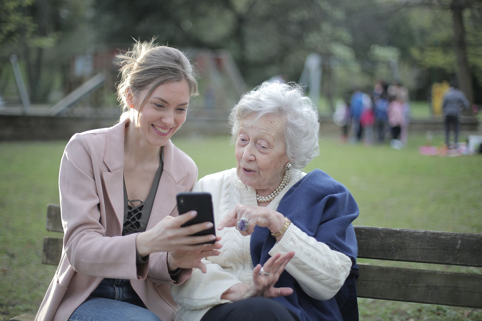 Carer helping elderly women with her phone