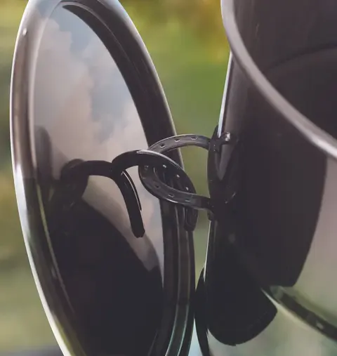 pit barrel lid resting on handle