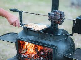 rotisserie chicken spinning on a barbeque