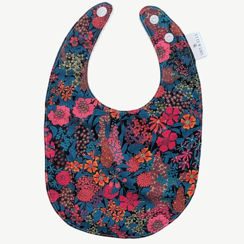 Handmade baby dribble bib in Liberty London floral fabric with absorbent bamboo towelling backing and snap fastening.