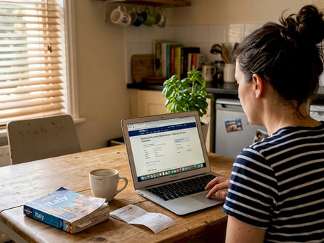 Woman at kitchen table booking hotel online
