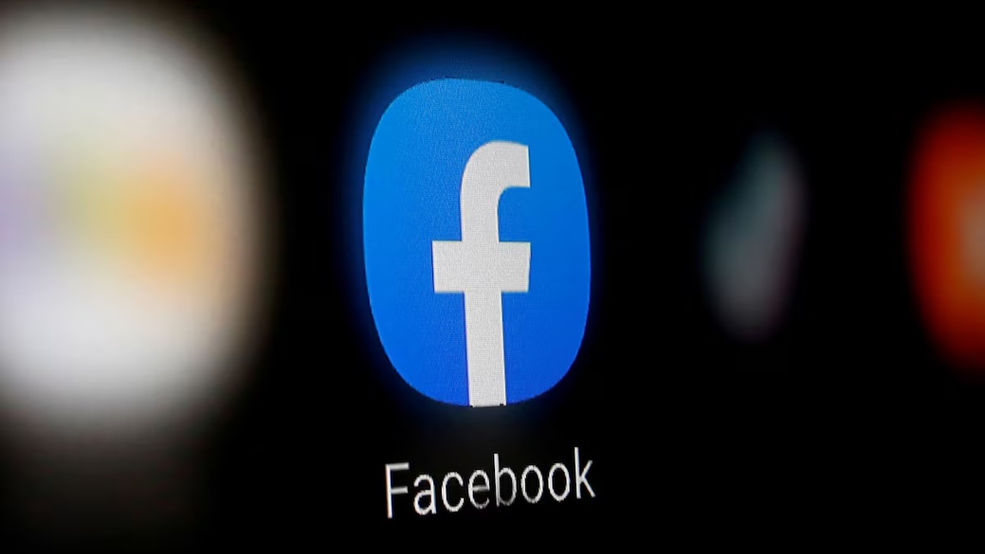 Picture of Facebook's logo on a screen