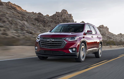 A red Chevrolet SUV traveling with auto insurance.