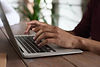 Person typing on a laptop.