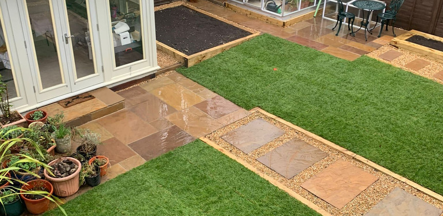 a landscaped garden with outbuilding