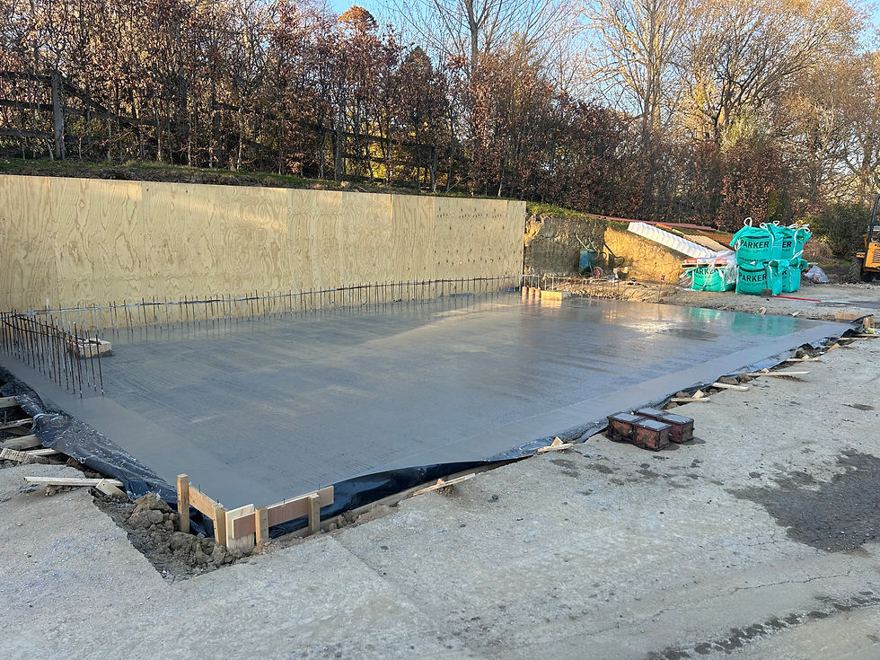 Freshly poured concrete slab at an outdoor construction site