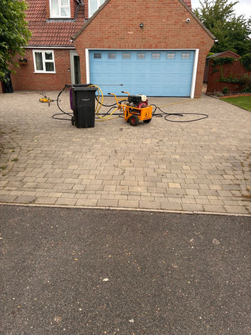 a driveway next to a garage