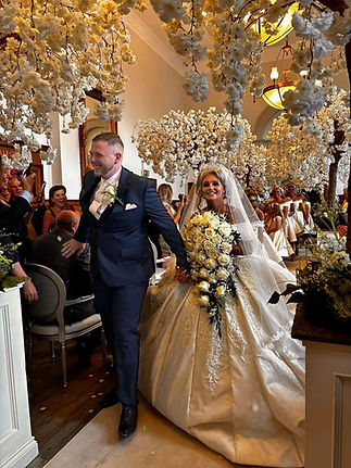 bride holding a bouquet of roses at her wedding