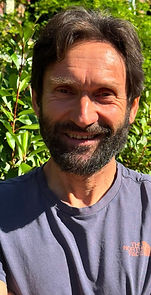 Smiling man with a beard outdoors for Meet The Team.