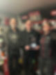 a group of three people with an award