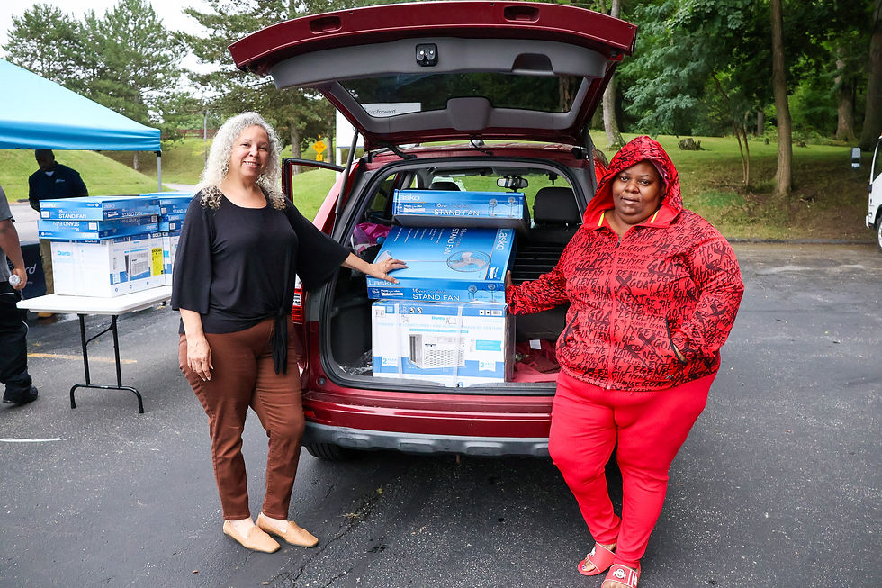 LaVonne (left) helps her client Jateir (right) pick up fans and an air conditioner.