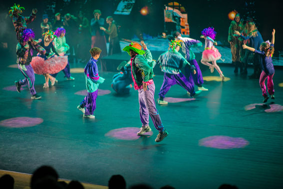 barn og ungdom danser på scenen i Hamar kulturhus med ledskjermer til scenografi med PS:Dans juleforestillingen julestjernen