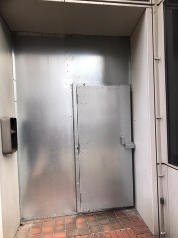 wall covered in metal sheet plus a metal door