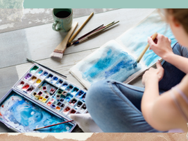 Woman using watercolour paints to express emotions