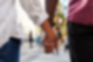 Close Up Of Male Couple Holding Hands On Urban Street .jpg