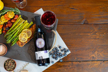 dinner plate next to a bottle of wine and a wine glass