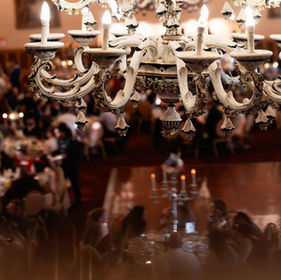 Guests seated beneath an ornate ballroom ceiling at the President's Ball