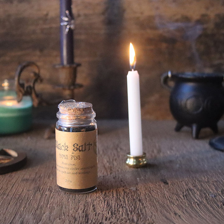 Thumbnail: Black salt pictures with a lit white candle