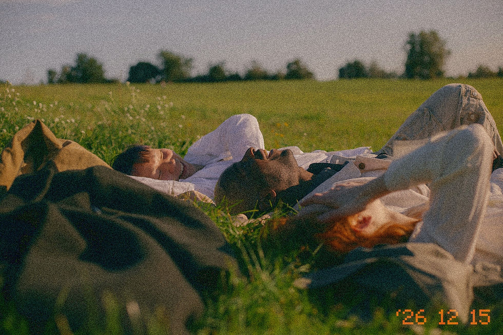 people laying in a field laughing