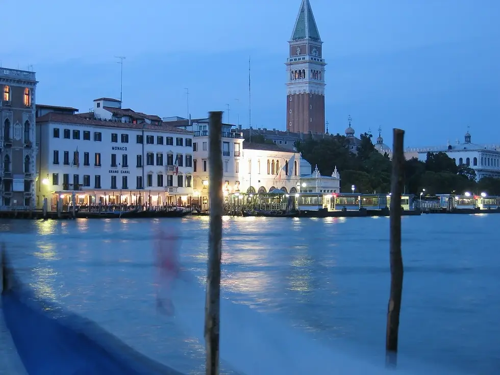 Venice waterfront at dusk with the bell tower of San Giorgio Maggiore across the lagoon