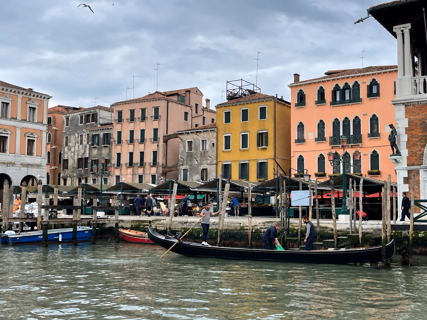 Gondoliers beside the Rialto fish market on Venice’s Grand Canal.