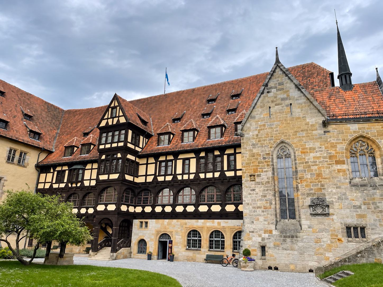 Half-timbered buildings and the stone castle chapel surrounding a courtyard inside Veste Coburg.