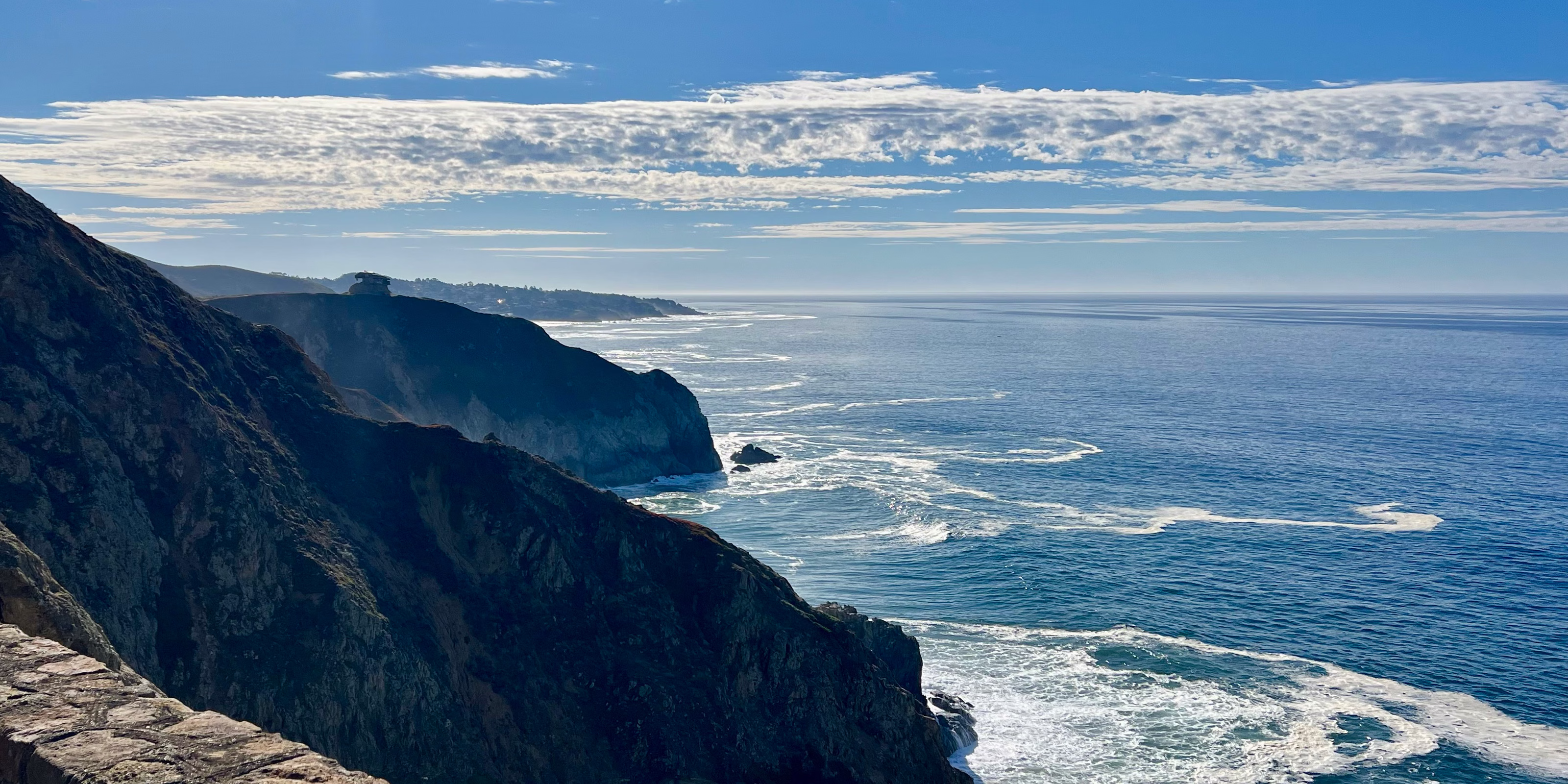Rugged cliffs and Pacific Ocean surf along California’s Highway 1 coast.