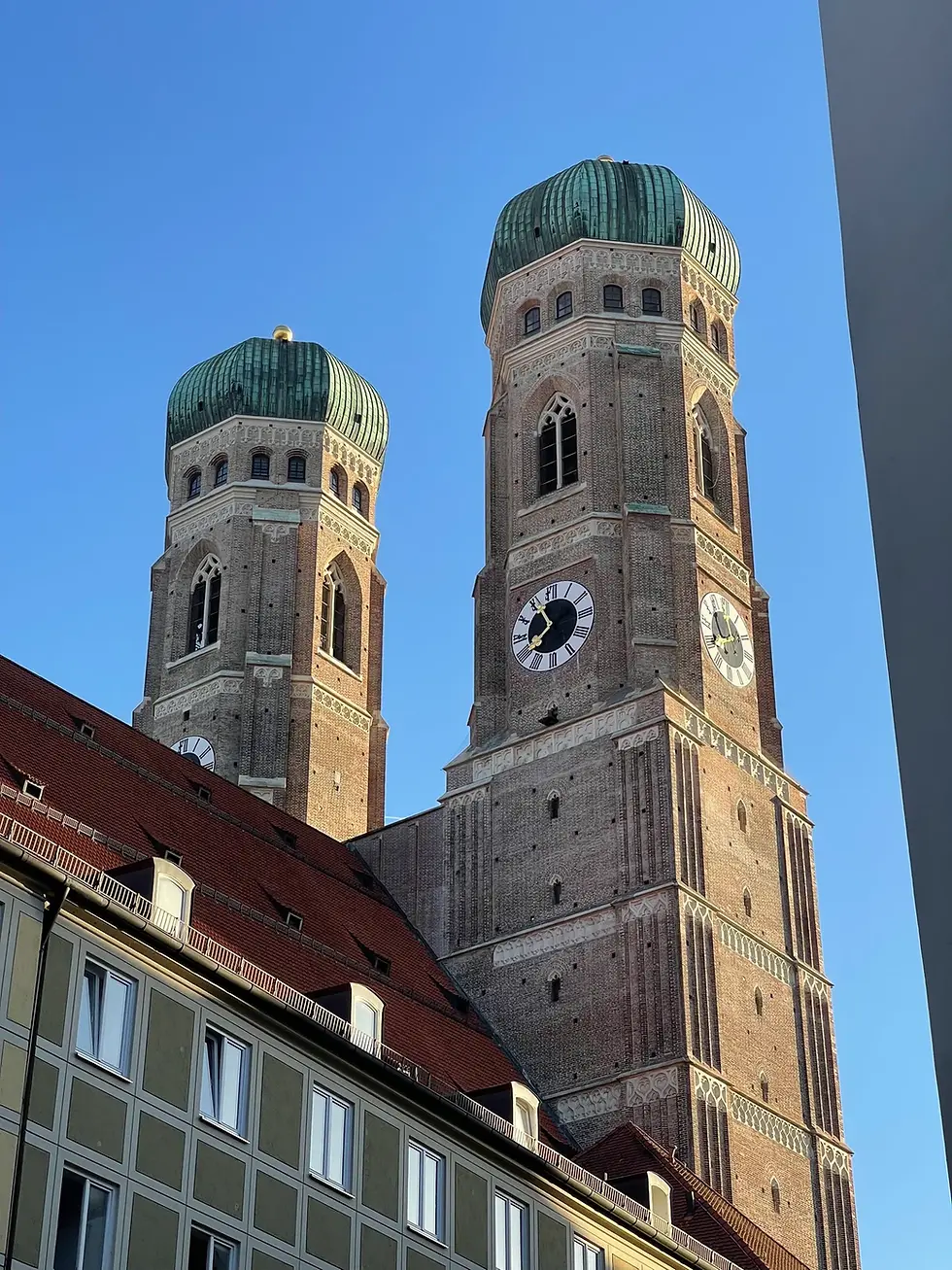 Munich's Frauenkirche towers above red roofs and the historic city center