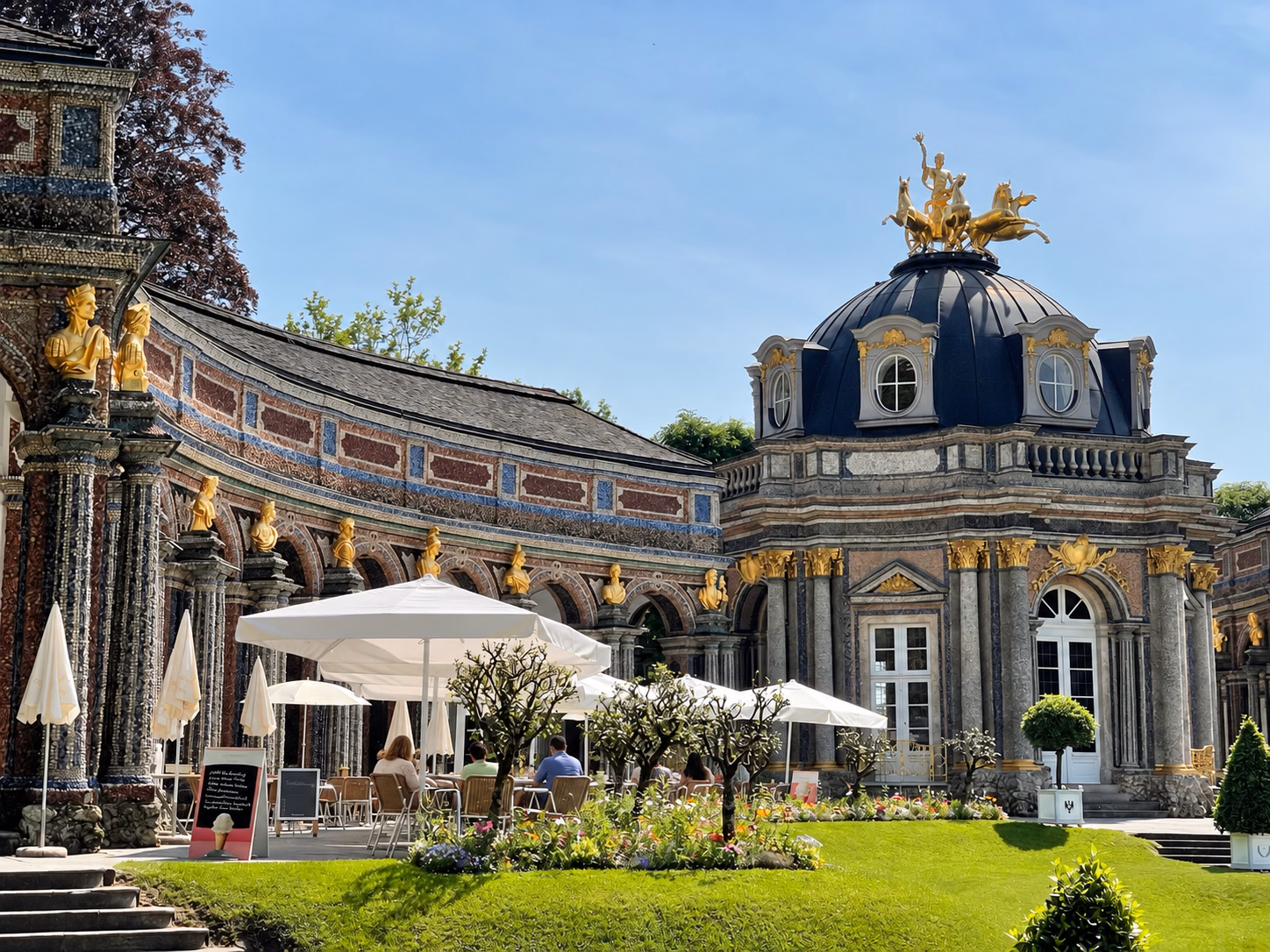 The ornate Sun Temple at Bayreuth’s Hermitage, surrounded by gardens and an outdoor café