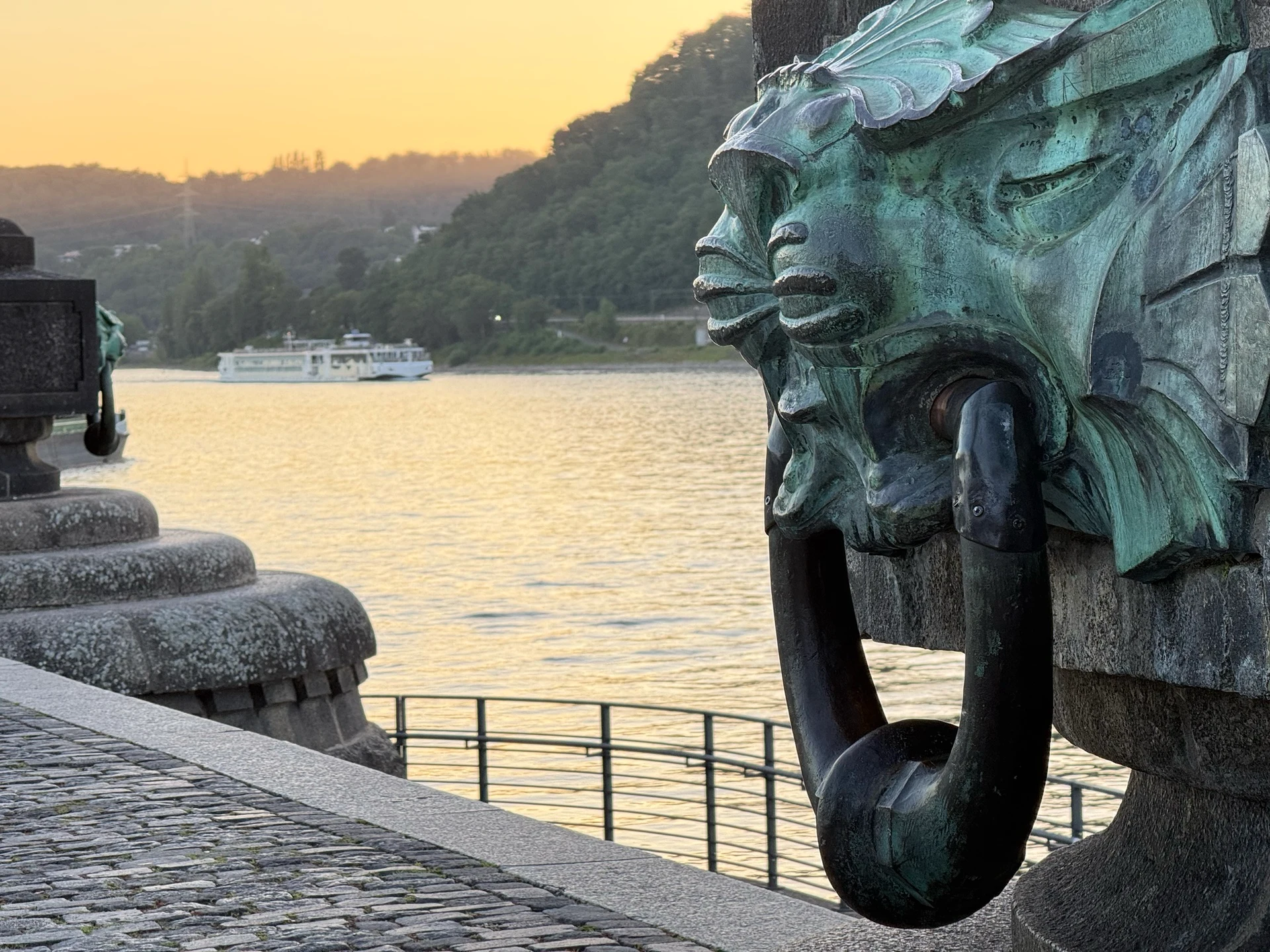 Cruise ship passing the Deutsches Eck on the Rhine in Koblenz at sunset