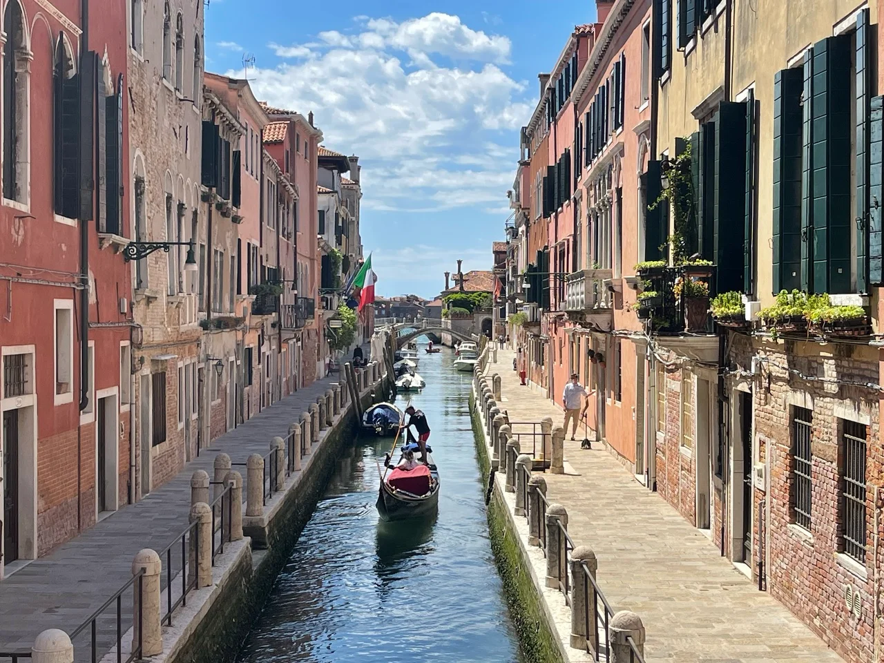 Quiet canal and narrow lanes in Venice, a four-night stop on the Munich to Milan journey.