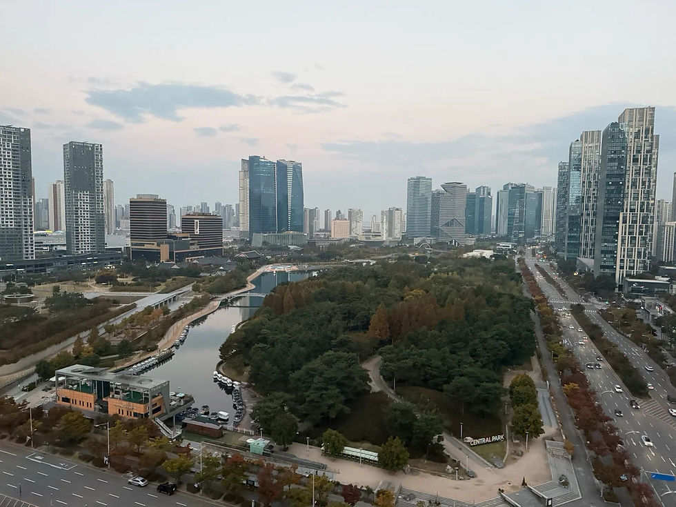 Waterway, wooded paths and surrounding high-rises in Songdo Central Park.