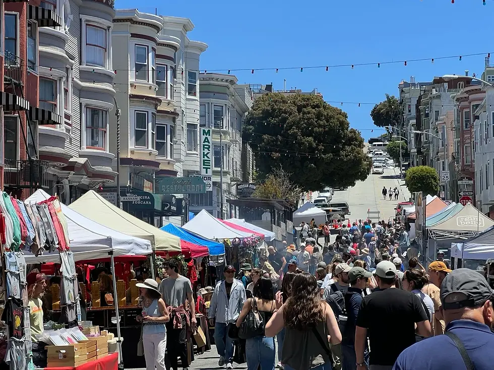 Crowds browsing vendor tents at San Francisco's North Beach street festival.