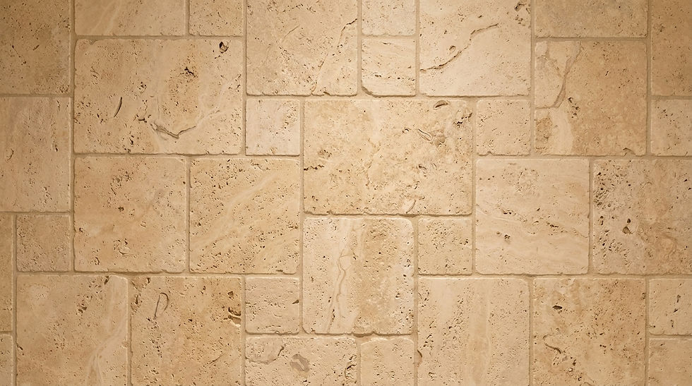 Surface detail. a close up of random ashlar (puzzle-piece) stone masonry comprised of travertine stone