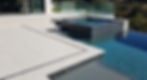 backyard detail. Large format porcelain pavers with rectified edges around a polished quartz coping pool, with a raised spa out of the pool with large polished tile.