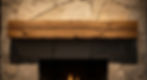 Detail shot of a 'Rustic' interior feature. A fireplace wall made of split-face stone with jagged, irregular edges. A mantel made of a rough-hewn, reclaimed timber beam with cracks and knots. The texture is aggressive and shadows are deep.