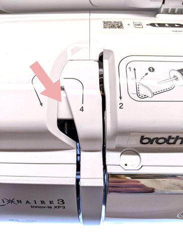 Shows take up lever being covered up because the presser foot is lowered