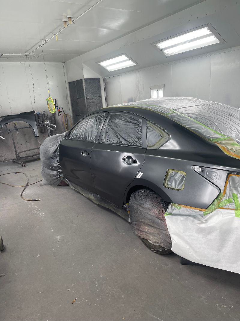 Close-up of dent removal by technician