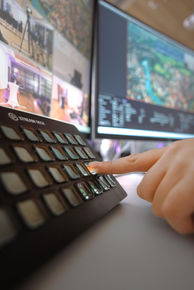 Ein Finger drückt auf den Knopf eines Streaming-Decks
