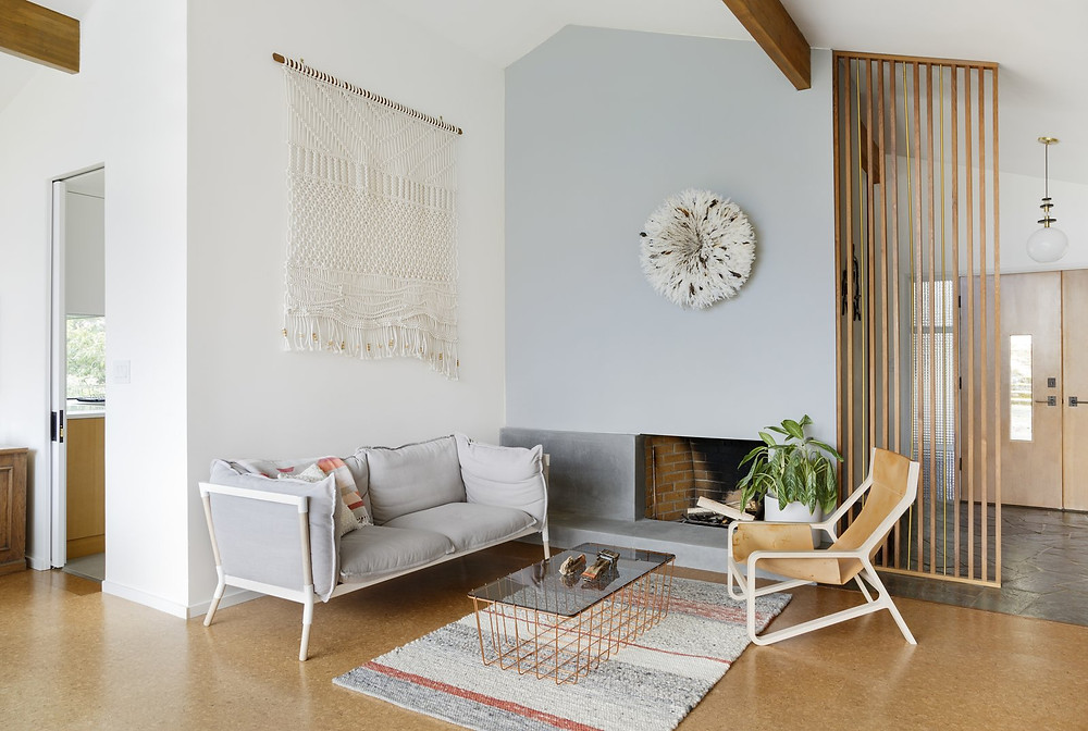A macramé wall hanging serves as large-scale, textural artwork in this sitting room
