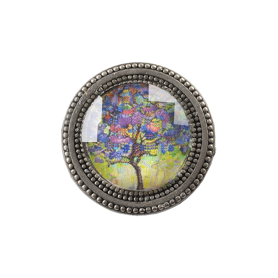 golden magnetic pin with painting of a tree in purple and yellow under a faceted crystal