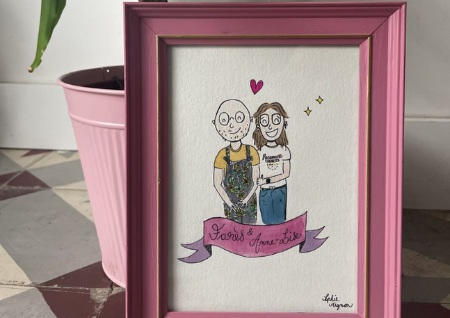 Couple portrait 'Happy Anniversary' with pink frame, plant, and pink pot. Les Créations de Sophie Mignon