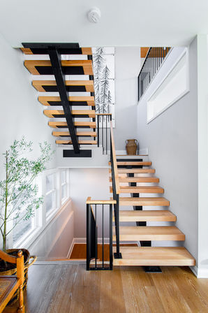 Alternate view of custom floating staircase with maple treads and modern railing—competitively priced without compromise on quality.