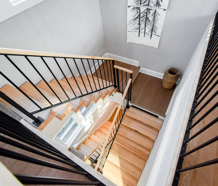 Alternate view of custom floating staircase with maple treads and modern railing—competitively priced without compromise on quality.