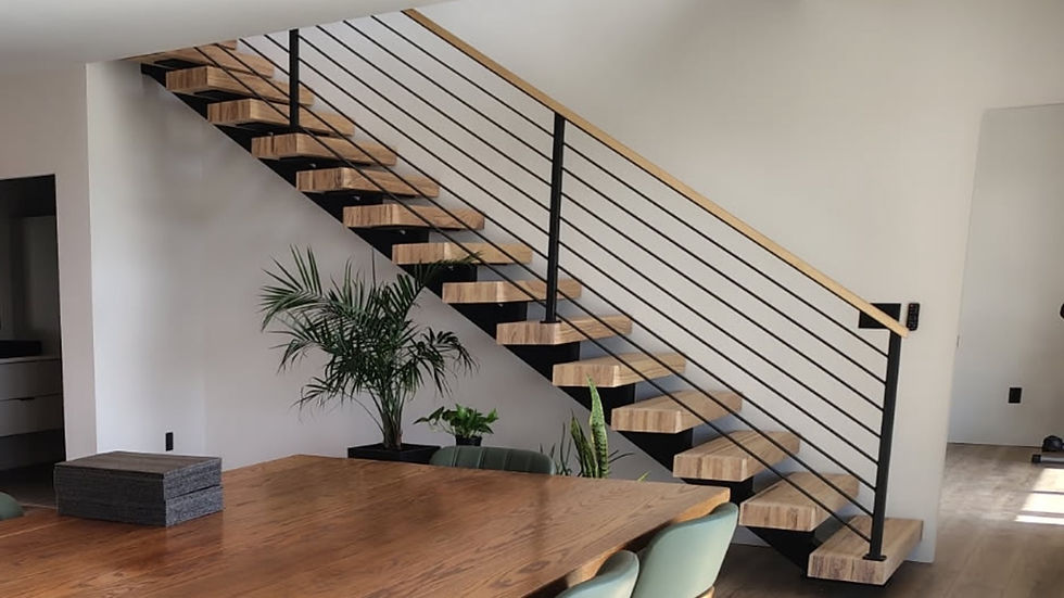 Custom floating staircase installed in an existing residential home with hardwood treads and steel monostringer