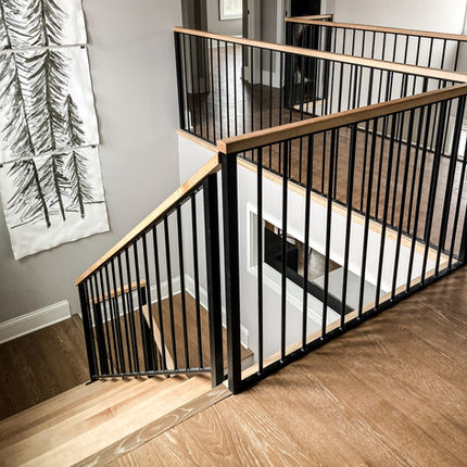 Custom welded steel railings installed around a staircase landing