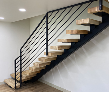 L-shaped floating staircase featuring solid white oak treads and black metal railing, designed for strength, precision, and affordability.