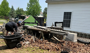 Coastal Junk Removal Solutions cleaning up a yard for a junk removal cleanup job near new bedford, massachusetts.